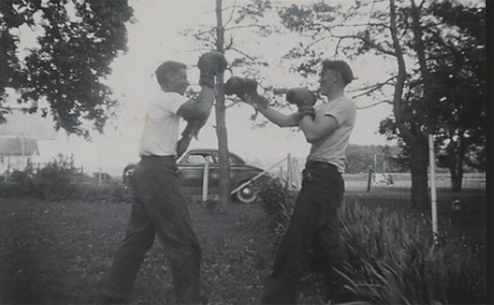 Vintage young man boxing outdoors with boxing gloves.