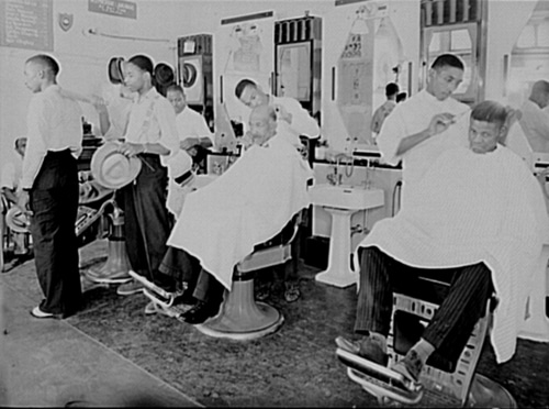 Vintage African American black barbershop men getting haircut.