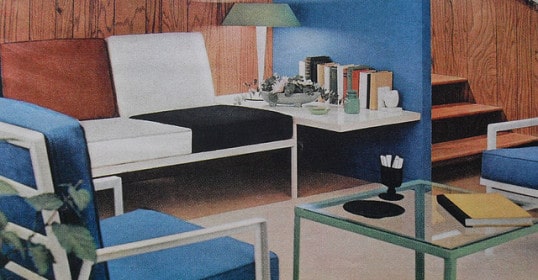 A minimalist living room with blue and white furniture.