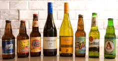 A group of beer bottles displayed on a counter.