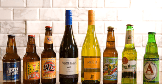 A group of beer bottles displayed on a counter.