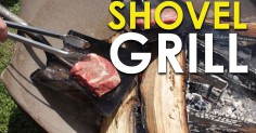 Using a shovel grill, the person is cooking a steak.