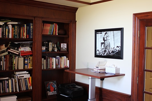 The Shelf Of Books in the Library and a Standing desk.