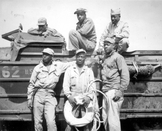 Vintage African American soldiers photo in front of truck.