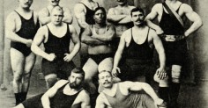 A group of strong wrestlers posing for a photo.