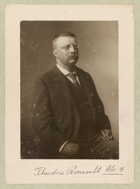 Frame of Teddy Theodore wearing suit and eyeglasses.