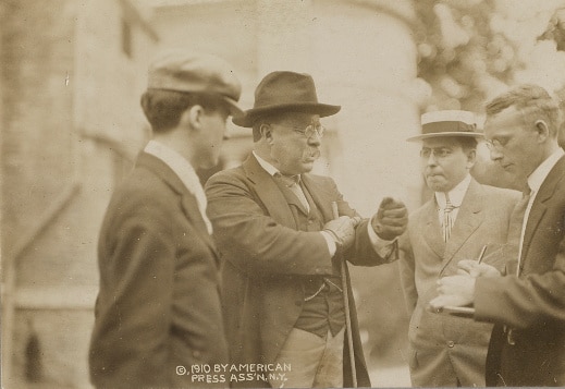 Teddy Theodore talking with group of men.