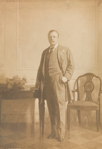 Teddy Theodore standing in room and wearing suit.