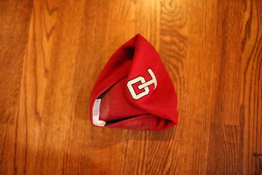 Folding a baseball cap.