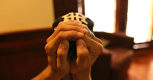 using hands to break in baseball hat bill