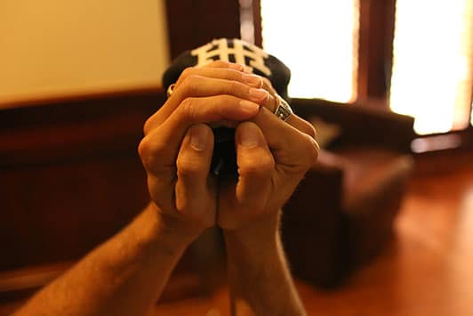 Man showing a folded shape of baseball cap.