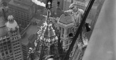 A black and white photo of laborers on a building.