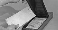 A person is protecting their legacy by opening a box with papers in it for estate planning.