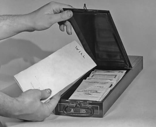 Vintage man putting will into safety deposit box. 