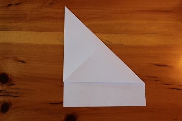 Step 2 — Fold and unfold top right corner to make a crease.