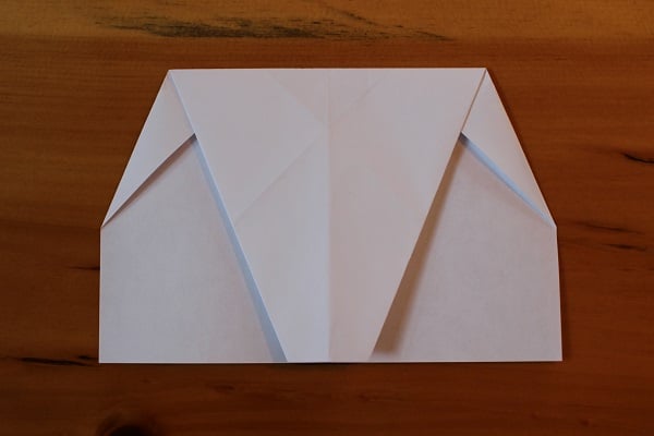 Top half folded down to meet the bottom edge.