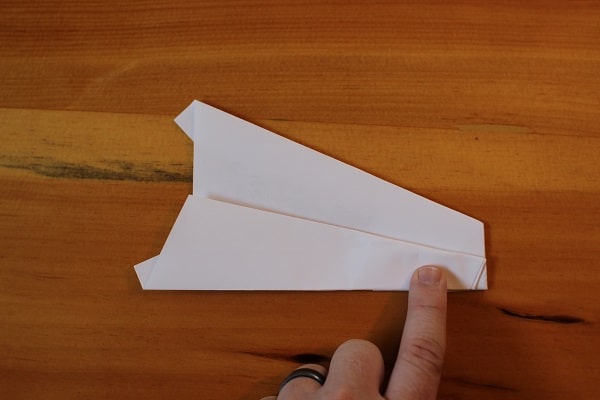 Fold wings down to meet bottom edge of plane. 