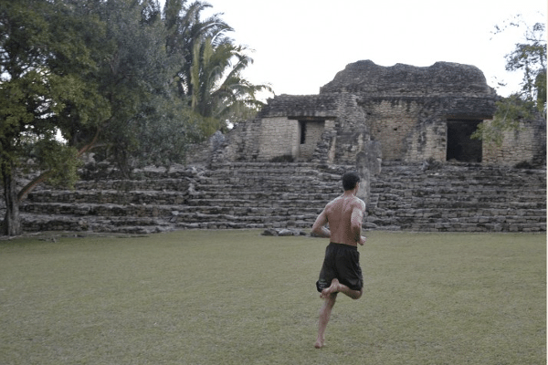 A man jogging in the ancient field.