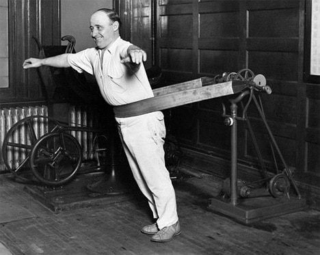 A man doing belt exercise at gym.