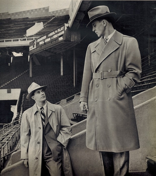 vintage college men 1948 in sports stadium wearing rain coats