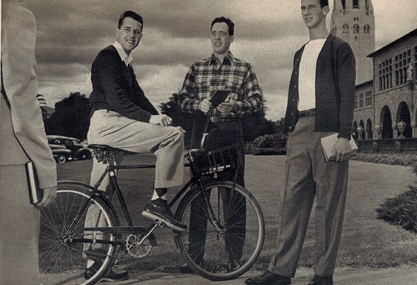 Casual comfort is what you want on the campus at west coast colleges. The cyclist wears a cashmere sweater, white shirt, gabardine slacks, argyles, crepe-soled moccasins; his classmate, a plaid shirt, covert slacks and ankle high chukka boots. Next, a cardigan sweater over a white tee shirt, gray flannels, brogue shoes.