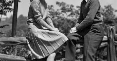 Monochrome photo of a man and woman perched on a fence, embodying the essence of clean communication.