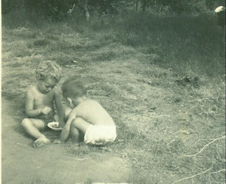 Vintage little boys playing in dirt and mud. 