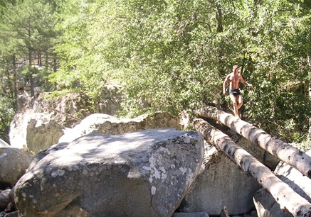 Man walking on bamboo in valley. 