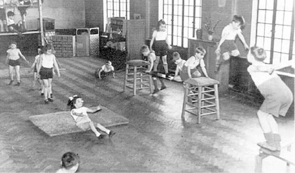 Children doing exercise in gym class. 