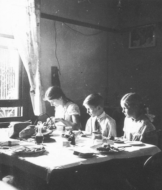 Vintage kids eating at dinner table. 