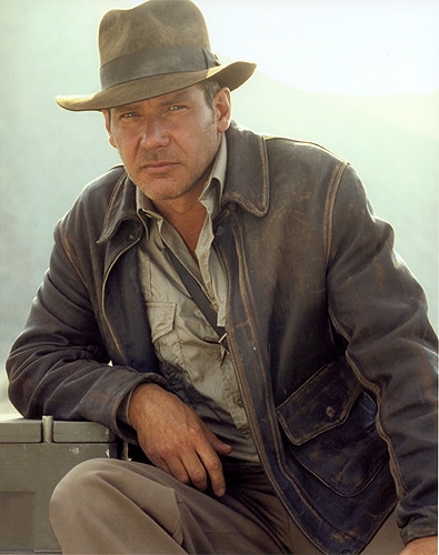 Harrison Fond wearing a leather jacket and cowboy hat. 