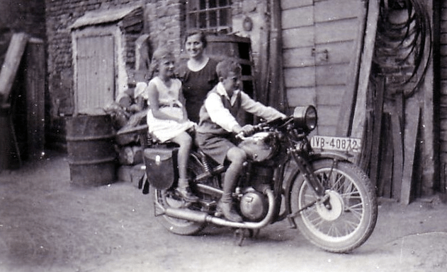 vintage mom posing with children on motorcycle