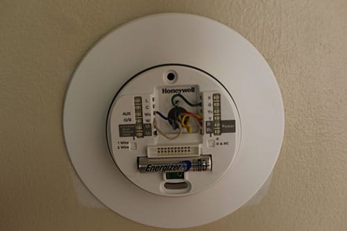 Placing new thermostat on wall.