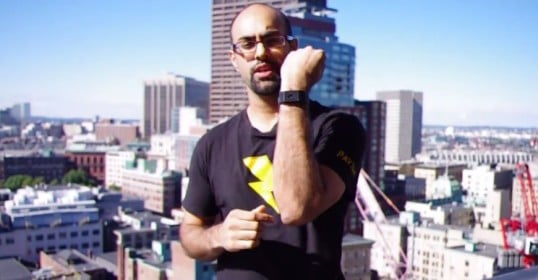 A man is standing on top of a building with a view of the city, reflecting on his habits.