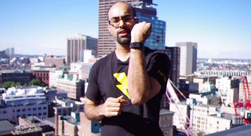 A man is standing on top of a building with a view of the city, reflecting on his habits.