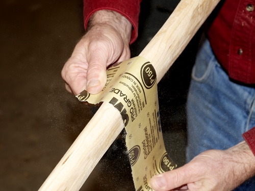 Diy ax handle sanding wood.