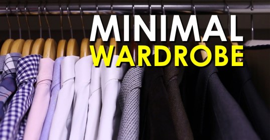 A minimal wardrobe displayed on a rack of clothes.
