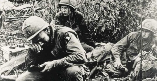 A group of soldiers are resting in the grass after receiving the Medal of Honor.