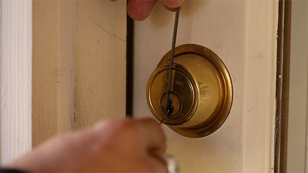 Inserting pick at top of lock.