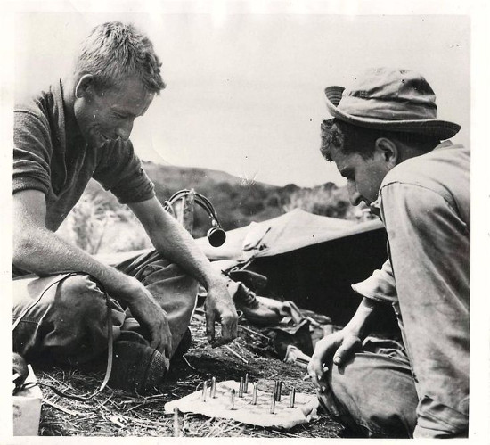 Vintage Men playing checkers on Grass field.