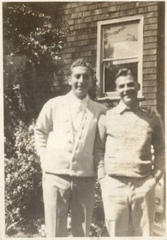 Vintage friends posing outside house. 