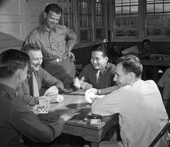Vintage men playing cards laughing smiling.