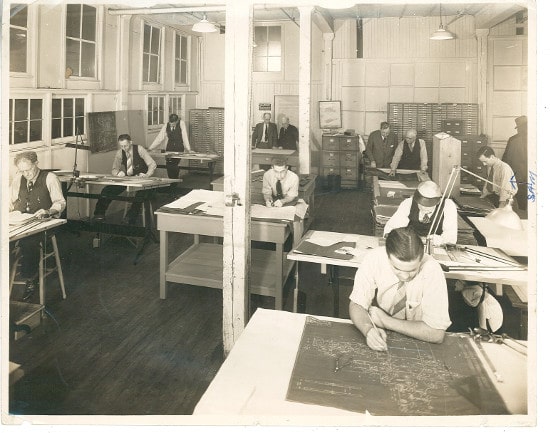 Vintage Architects office men looking at Blueprints. 