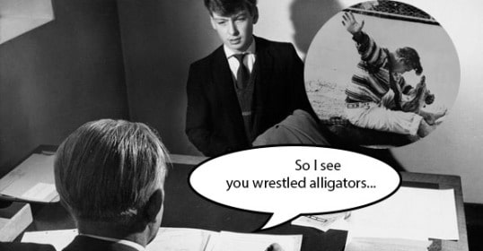 Two men in suits are conversing in an unconventional background.
