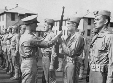 A group of men in uniform standing next to each other during WWII.