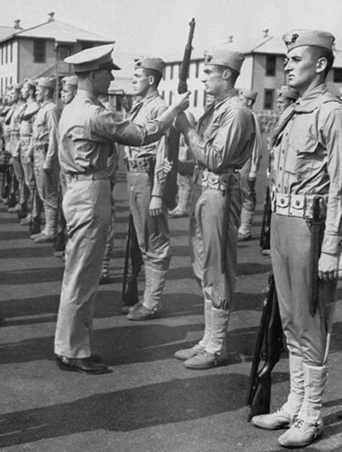 Vintage Soldiers standing in line at attention Sargeant fixing posture.
