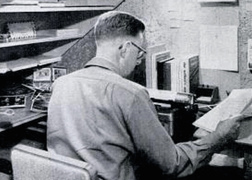A man working at a desk with papers.