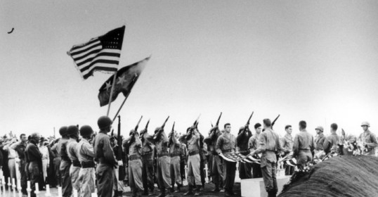 On Memorial Day, a brave group of soldiers stands solemnly in front of a grave.