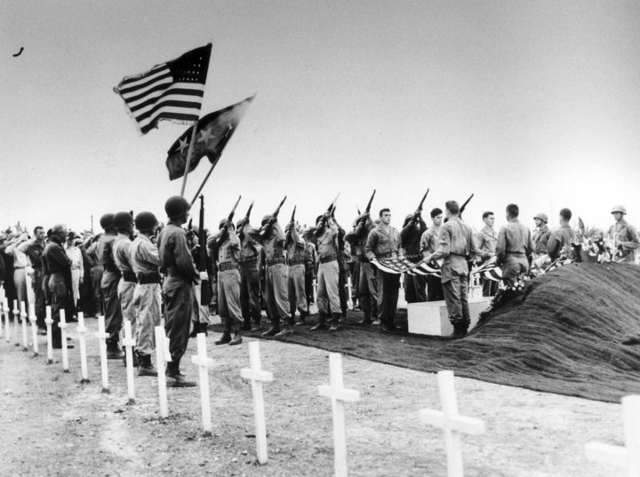 On Memorial Day, a brave group of soldiers stands solemnly in front of a grave.