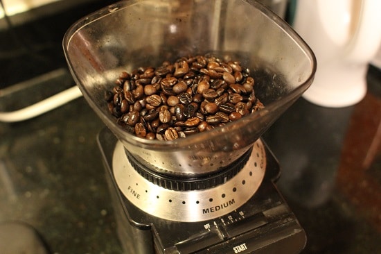 Grinding Coffee Beans in Burr Grinder. 